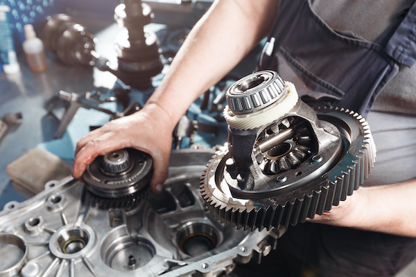 Home cross section of a car gearbox. mechanics work in the garage. hand mechanic in working clothes