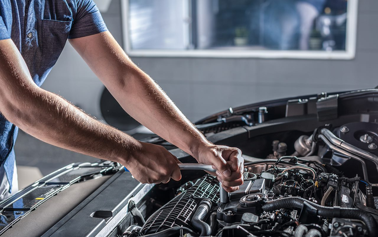 Home auto mechanic repairing a car
